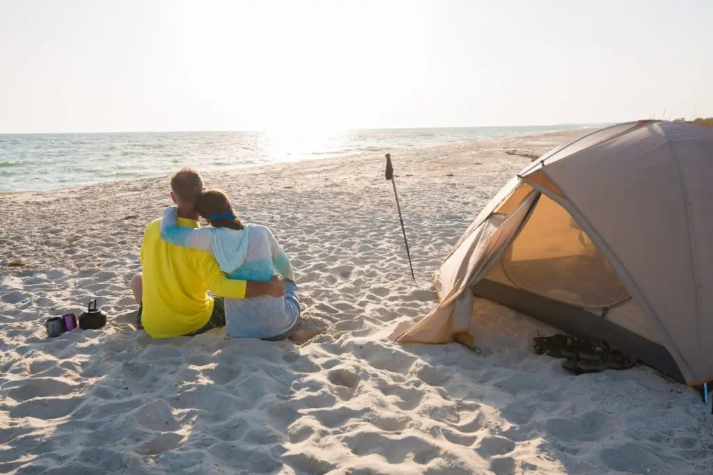 Couple Relaxing Near One of the Best Beach Tents