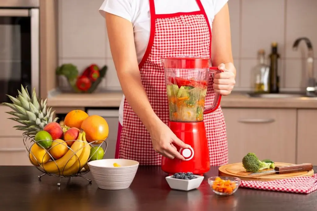 Woman Using one of the Best Blenders under 100