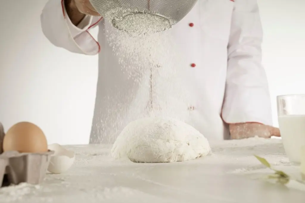 Chef powdering food with Bleached vs Unbleached Flour