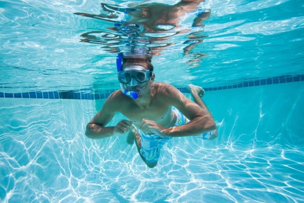 Young man snorkeling in a Chlorine or Saltwater pool
