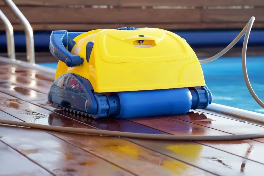 Robotic Pool cleaner at edge of pool types of pool cleaner