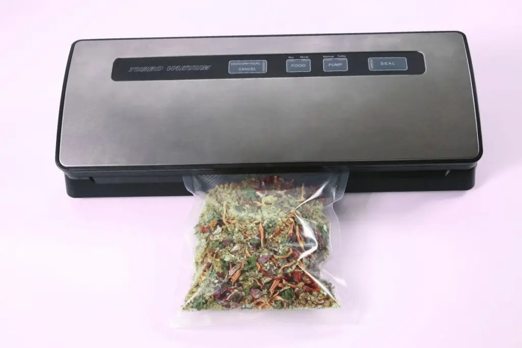Vacuum Sealer on Pink Background with Dry Foods