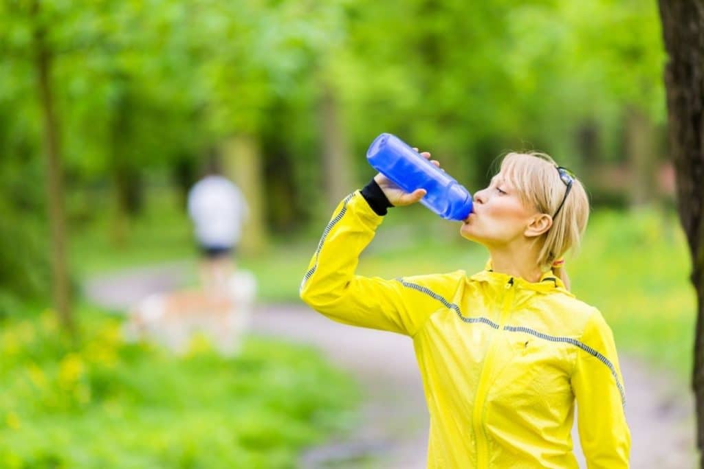Woman drinking from a water bottle with a filter best filtered water bottles