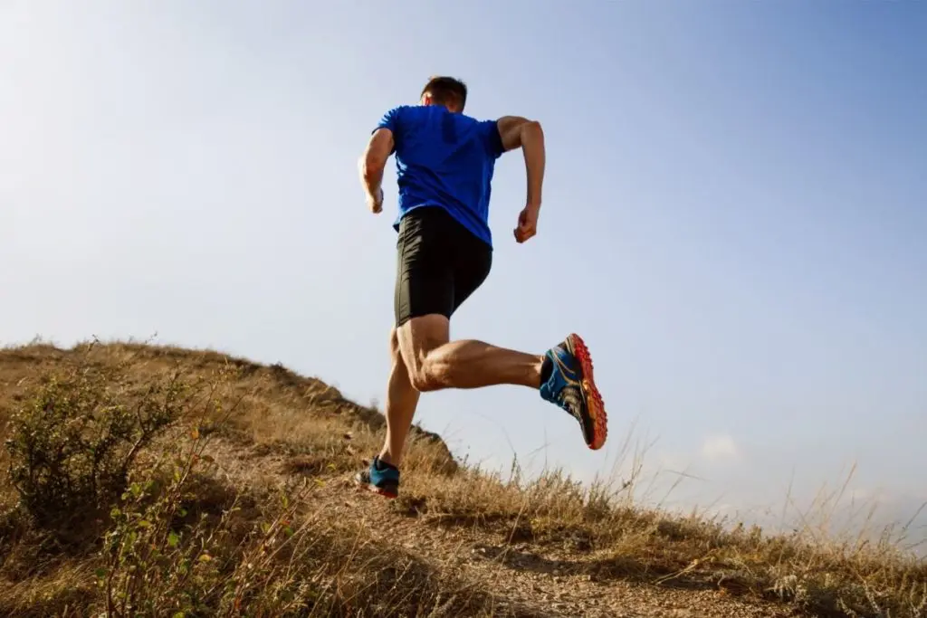 Man running up hill for cardio endurance training