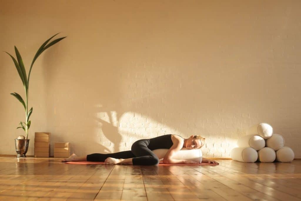 Person doing Restorative Yoga with a Yoga Roller