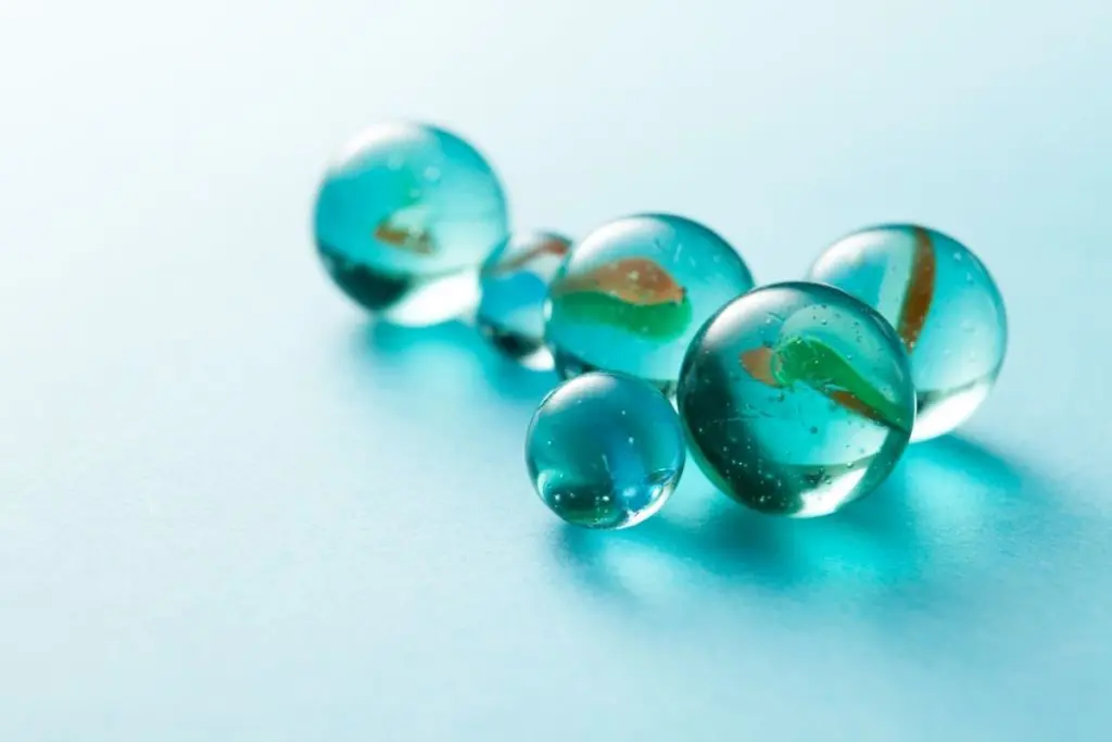 Marbles grouped together on a Blue background